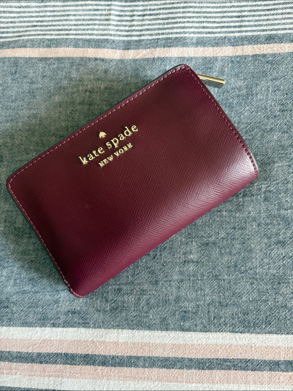 kate spade Burgundy Saffiano Zip Around Wallet with Gold Logo